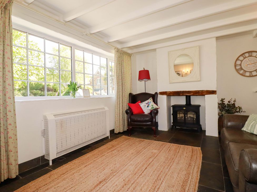 A living room with a fireplace and seating area at Millies Place in St Austell