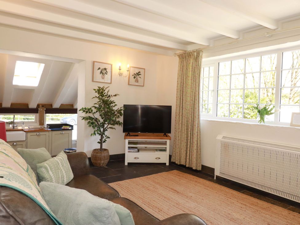 A living room with a sofa and tv at Millies Place in St Austell
