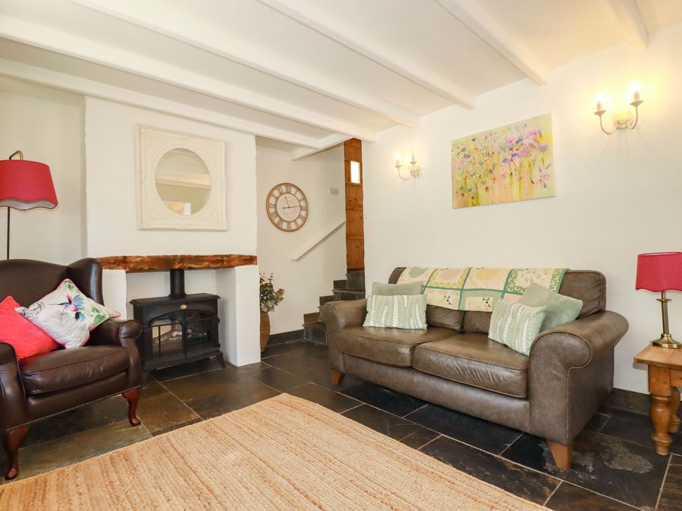 A living room with a sofa and armchair at Millies Place in St Austell