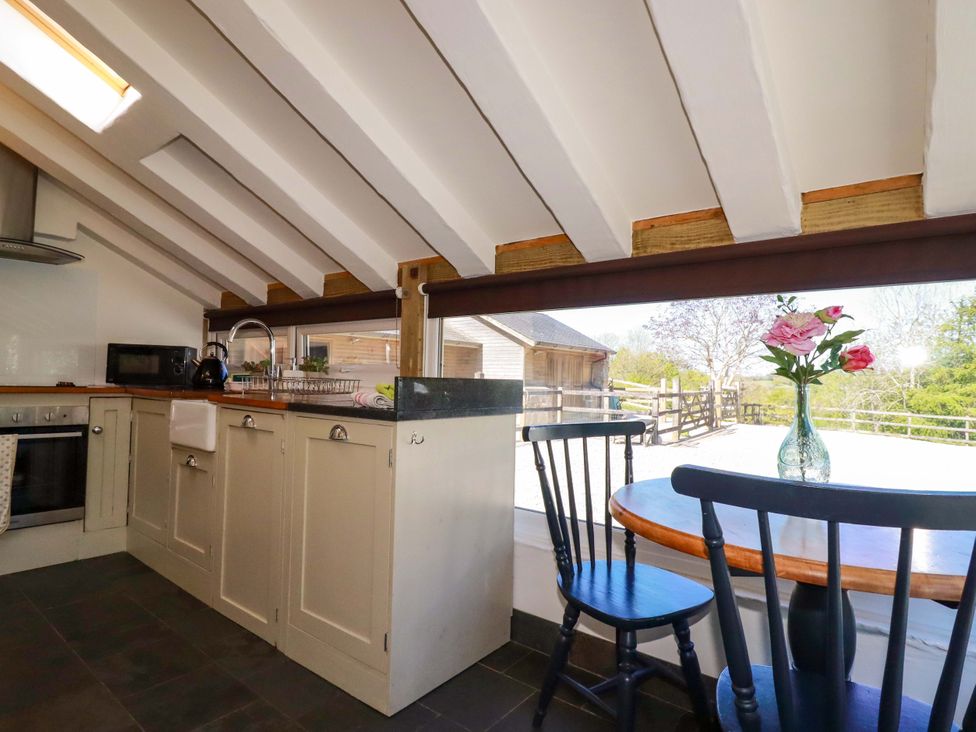 A kitchen with a sink and microwave at Millies Place in St Austell