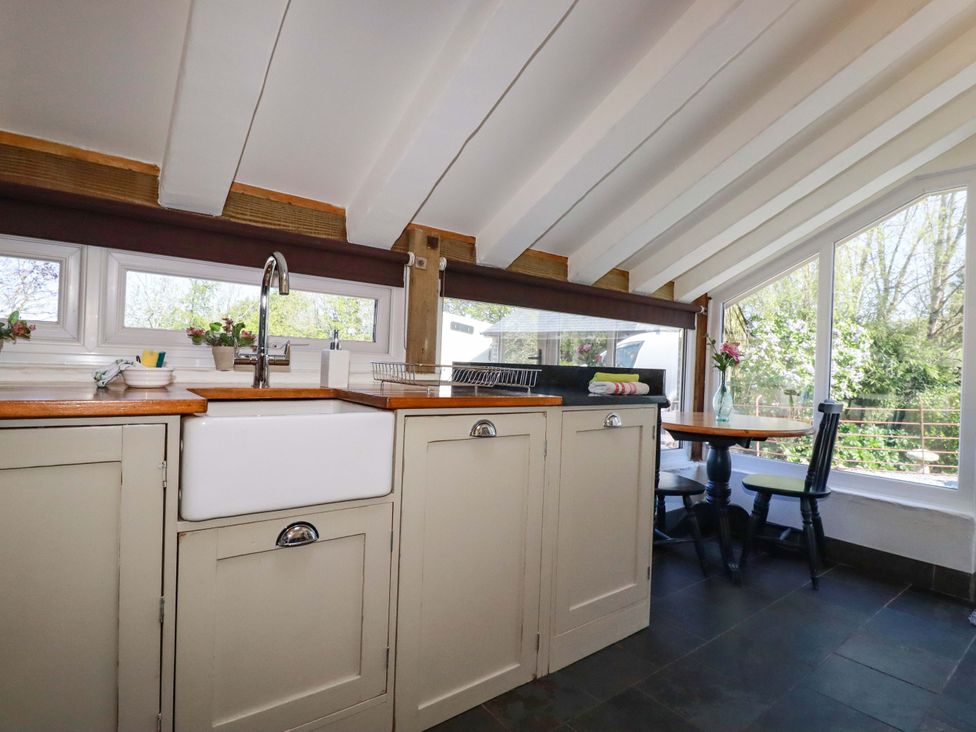A kitchen with sink and dining table at Millies Place in St Austell