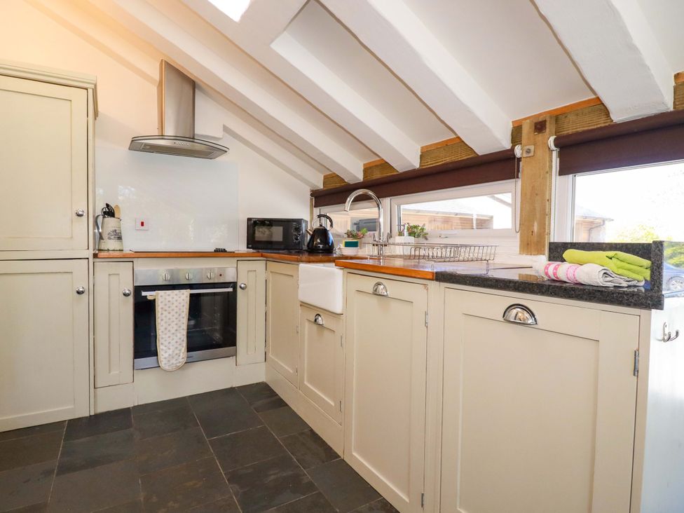 A kitchen with cabinets and appliances at Millies Place in St Austell