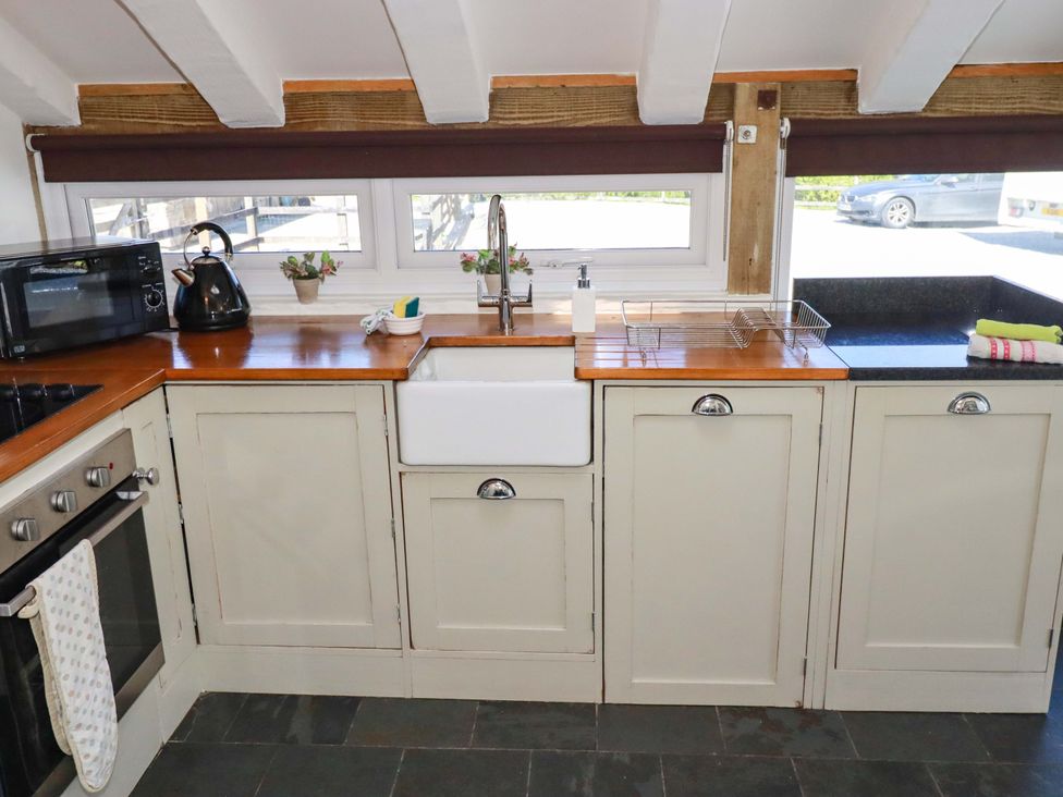 A kitchen with sink and appliances at Millies Place St Austell