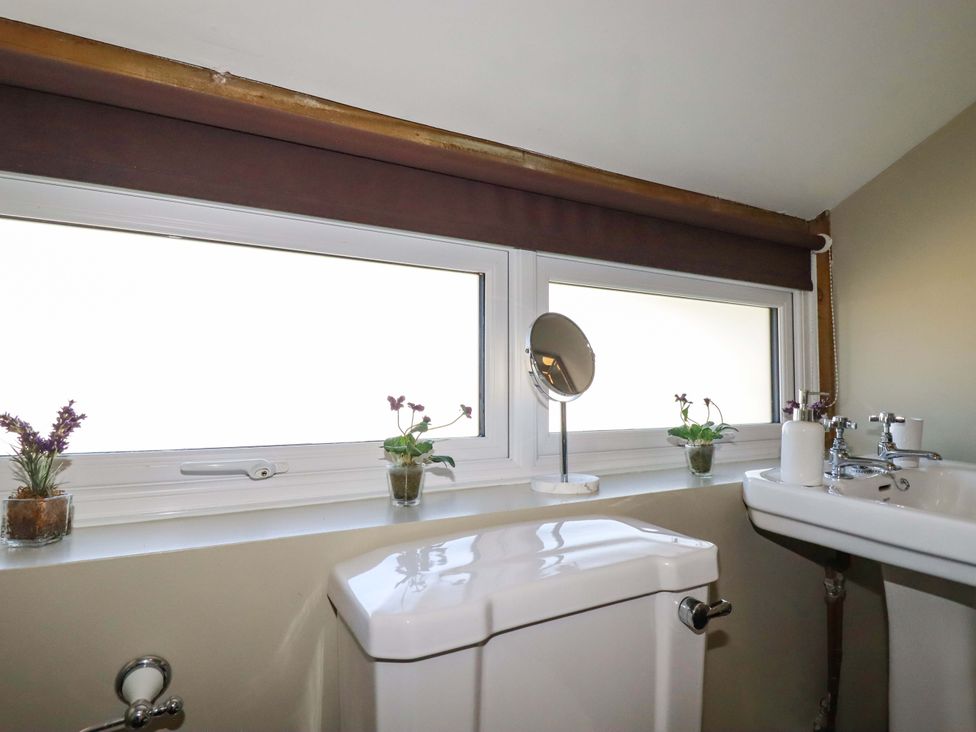 A bathroom with a toilet and sink at Millies Place St Austell