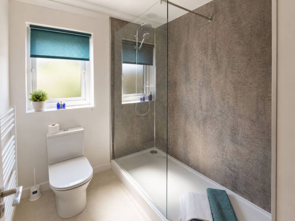 A bathroom featuring a shower and toilet at Beckside Cottage in Hebden Bridge