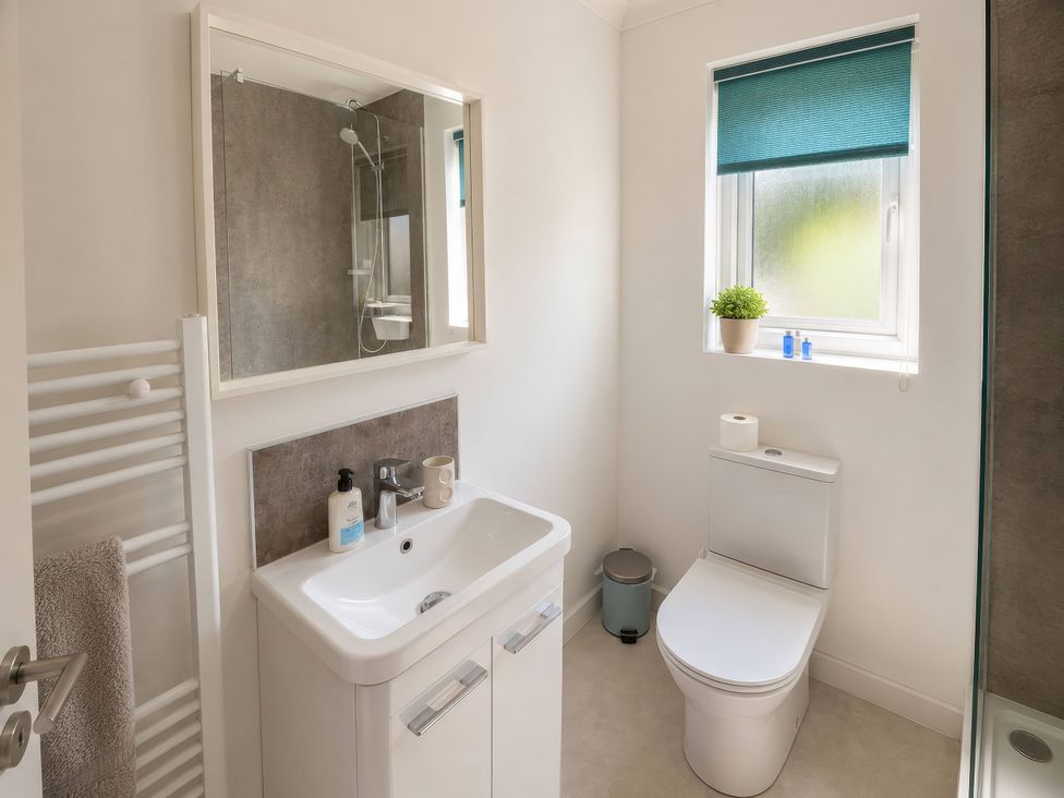 A bathroom with a sink and toilet at Beckside Cottage in Hebden Bridge