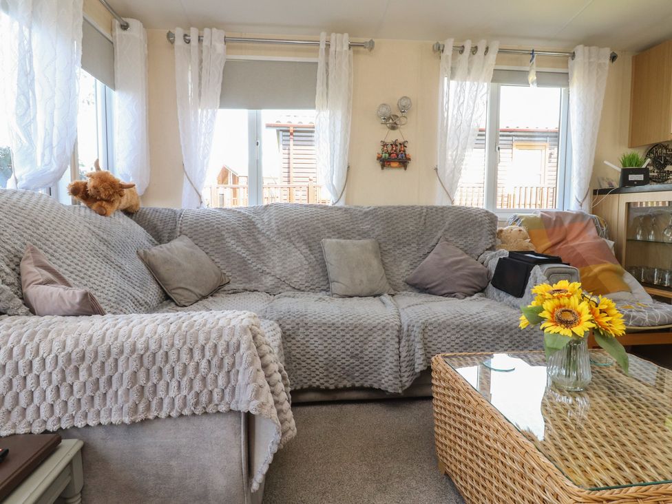 A living room with a couch and a coffee table at 33 Pendle View in Clitheroe