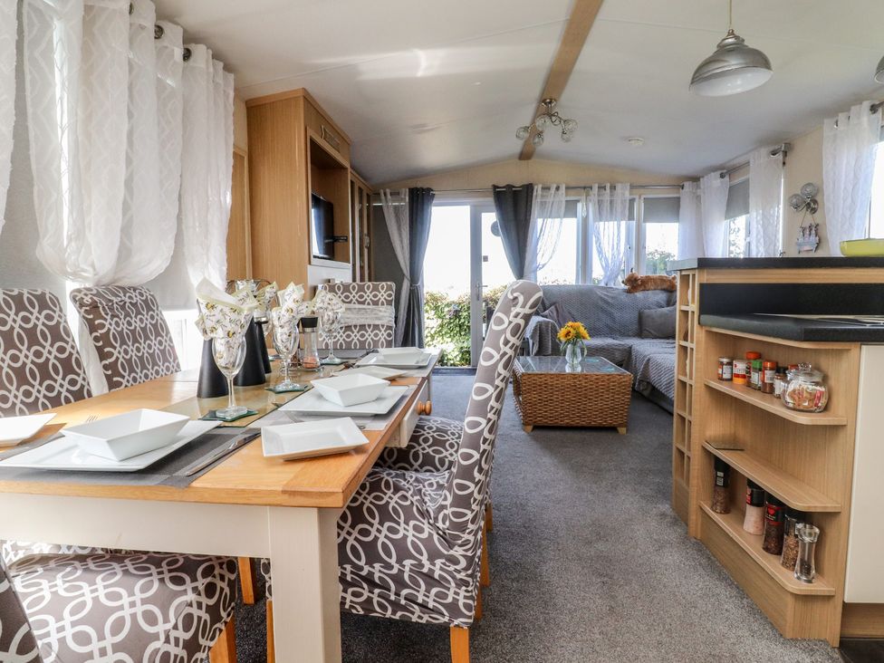 A dining area with a table and chairs at 33 Pendle View Clitheroe