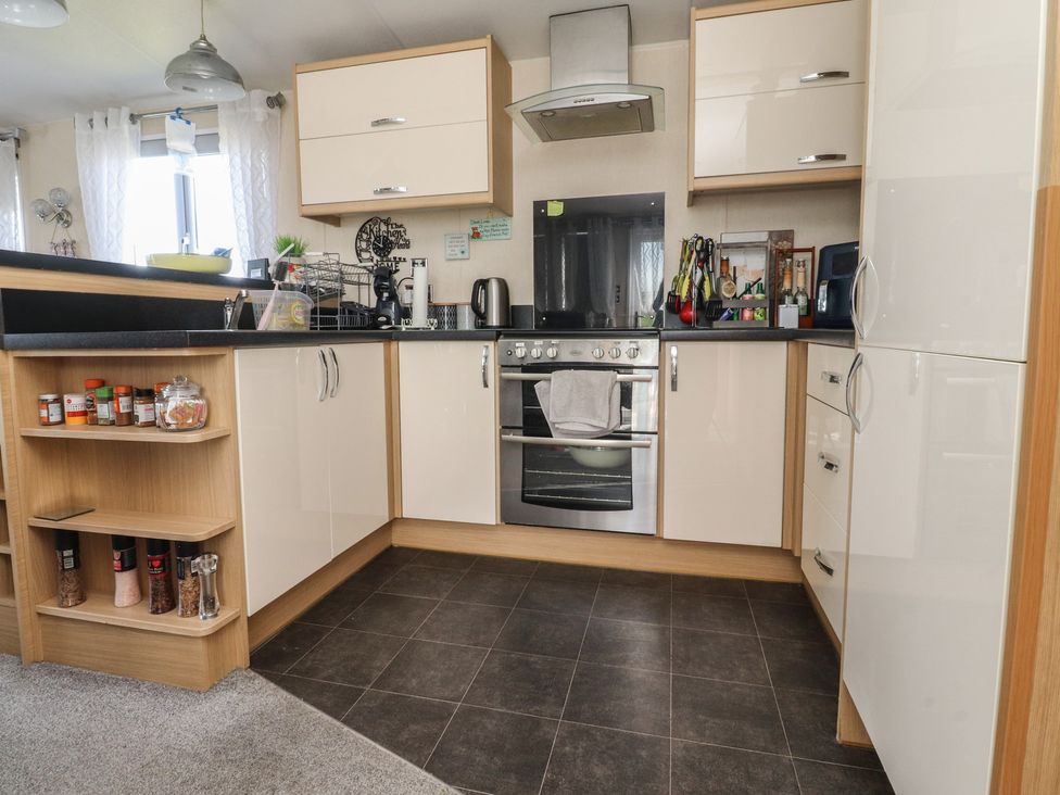 A kitchen with cabinets, oven, and sink at 33 Pendle View in Clitheroe