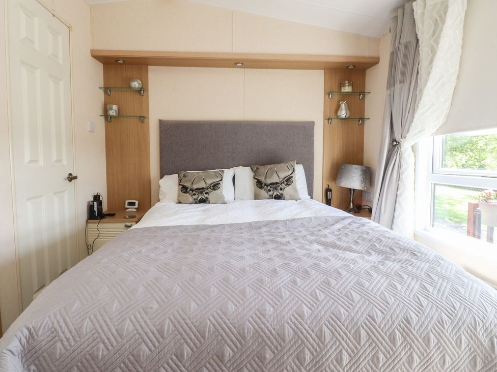 A bedroom with a bed and bedside table at 33 Pendle View in Clitheroe