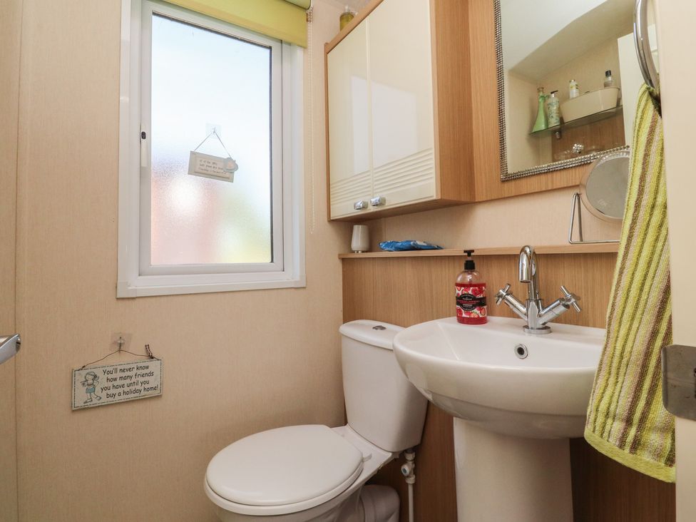 A bathroom with a toilet and wash basin at 33 Pendle View, Clitheroe