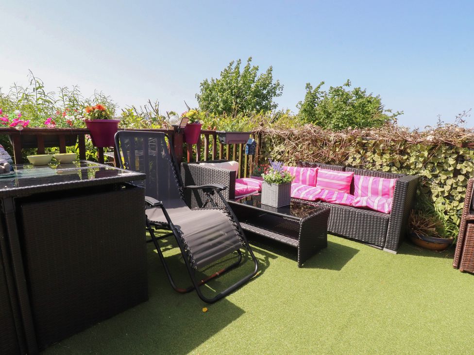 An outdoor seating area with a sofa and table at 33 Pendle View Clitheroe