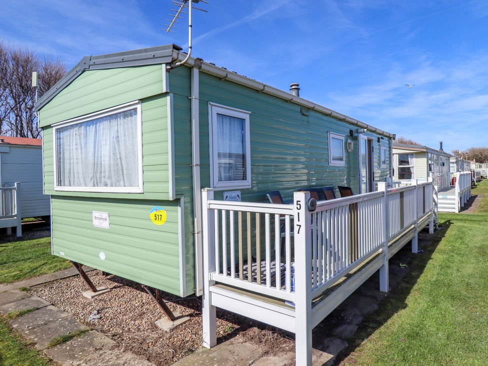 A caravan with a deck and windows at 517 - Promenade Caravan Site in Skegness