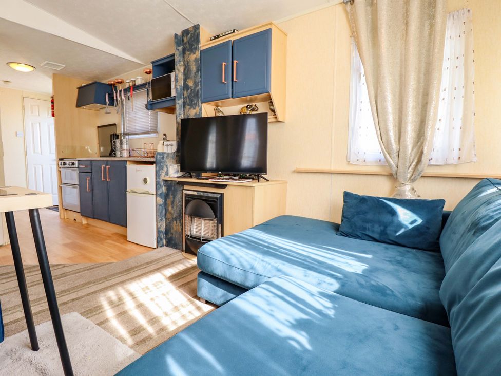 A living room with a sofa and television at 517 - Promenade Caravan Site in Skegness