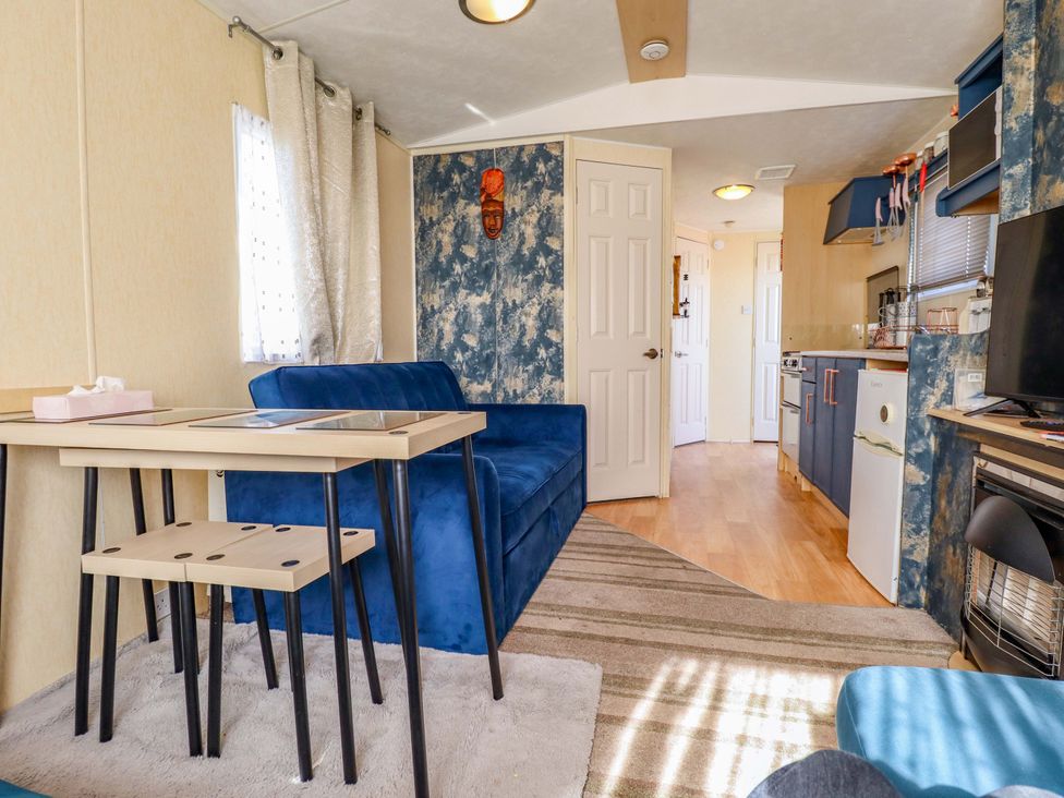 A living room with a sofa and table at 517 - Promenade Caravan Site in Skegness