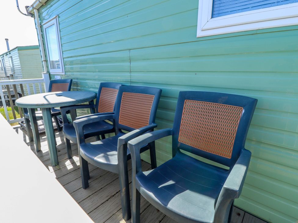 A table and chairs in outdoor space at 517 - Promenade Caravan Site in Skegness