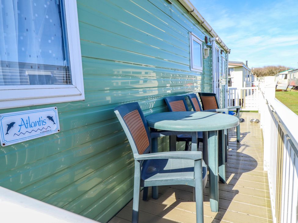 A balcony with a table and chairs at 517 - Promenade Caravan Site in Skegness