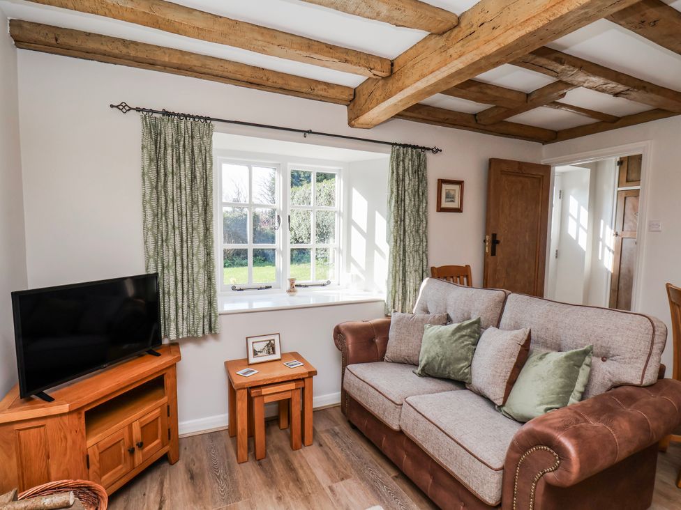 A living room with a sofa and television at Holly Cottage in Whitby