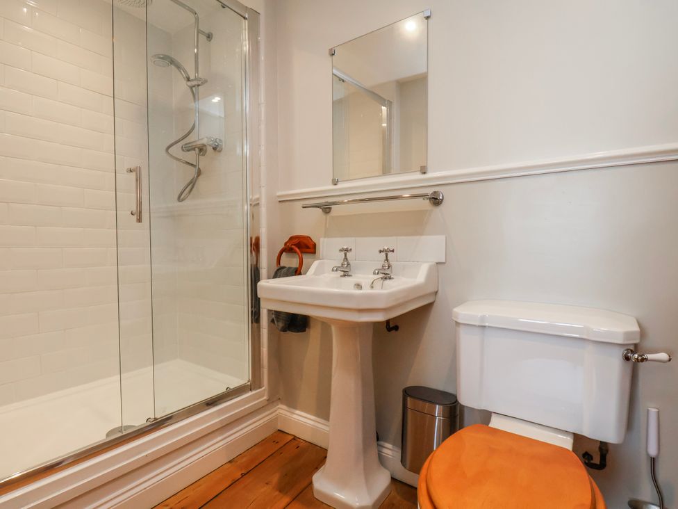 A bathroom with a shower and sink at Holly Cottage in Whitby