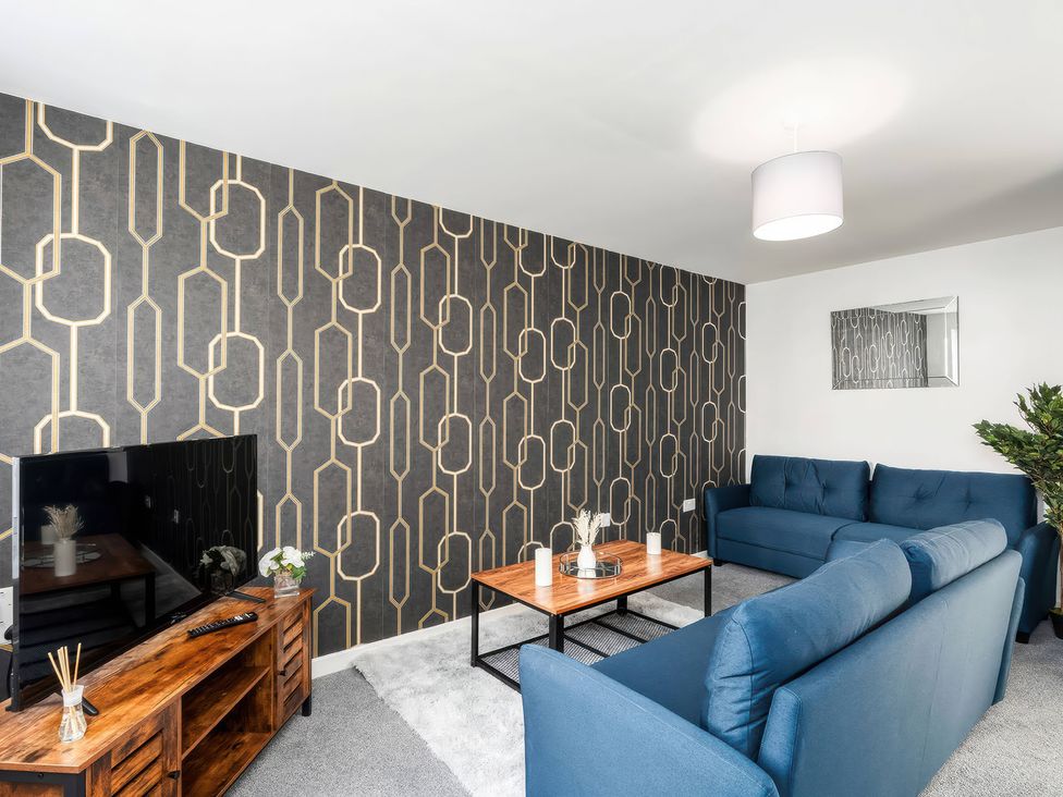 A living room with a television and sofa at 59 Eagle Drive in Grimsby