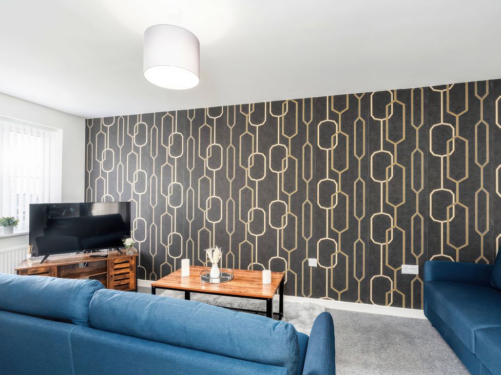 A living room with a television and a coffee table at 59 Eagle Drive in Grimsby