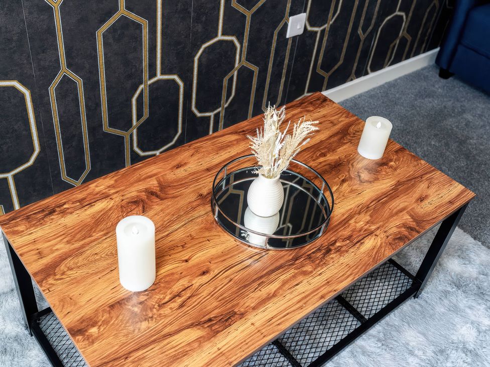 A coffee table with a vase and candles at 59 Eagle Drive in Grimsby