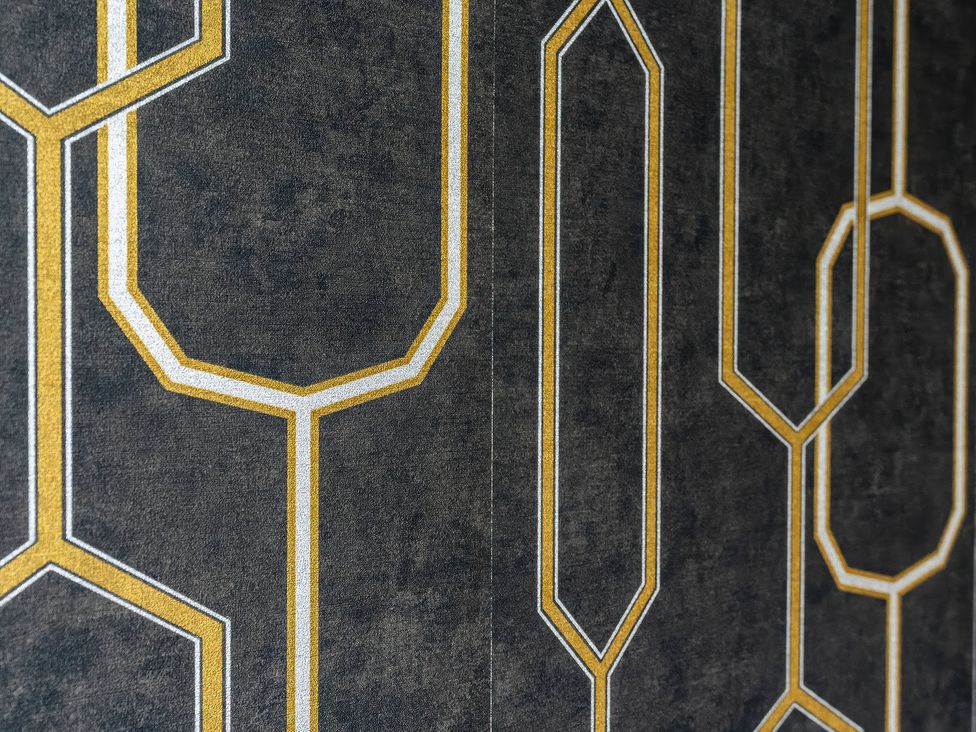 A wall with geometric patterned wallpaper at 59 Eagle Drive Grimsby