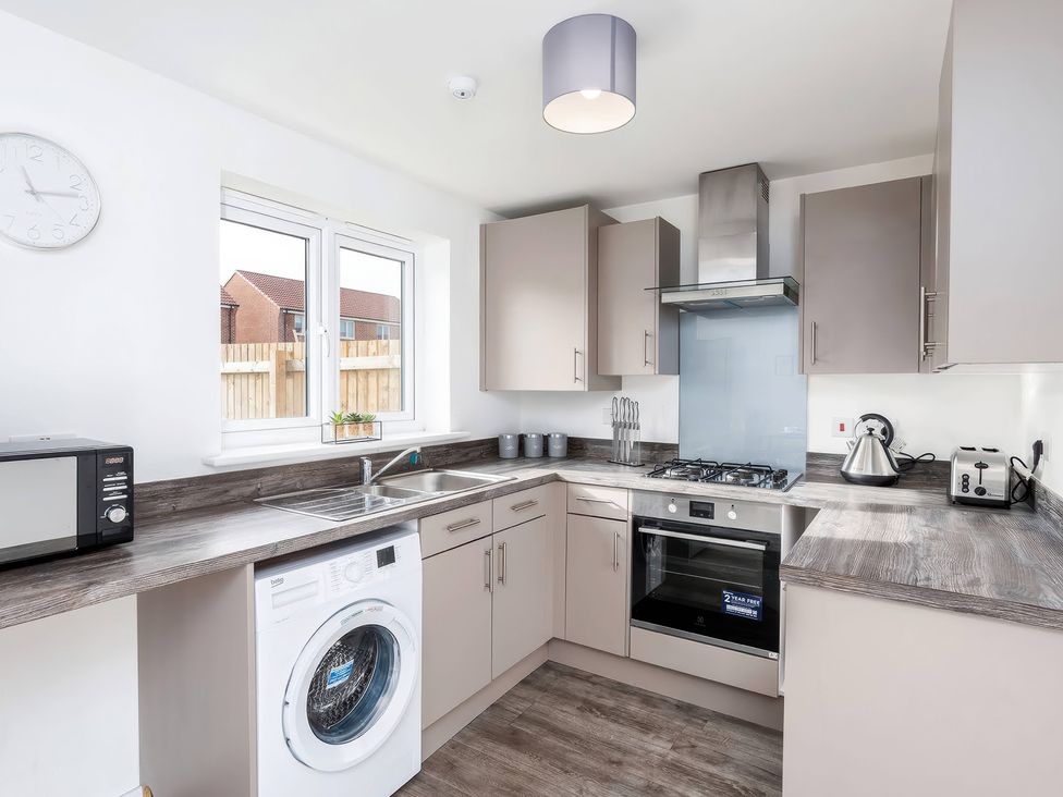 A kitchen with appliances and a window at 59 Eagle Drive in Grimsby