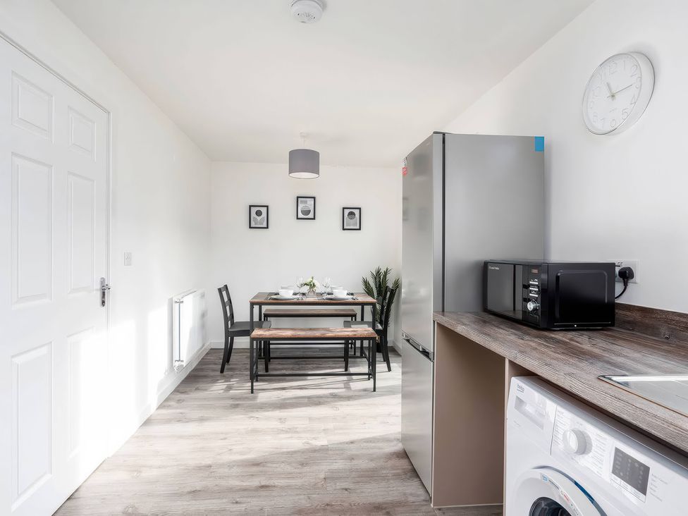 A kitchen with a table and chairs at 59 Eagle Drive in Grimsby