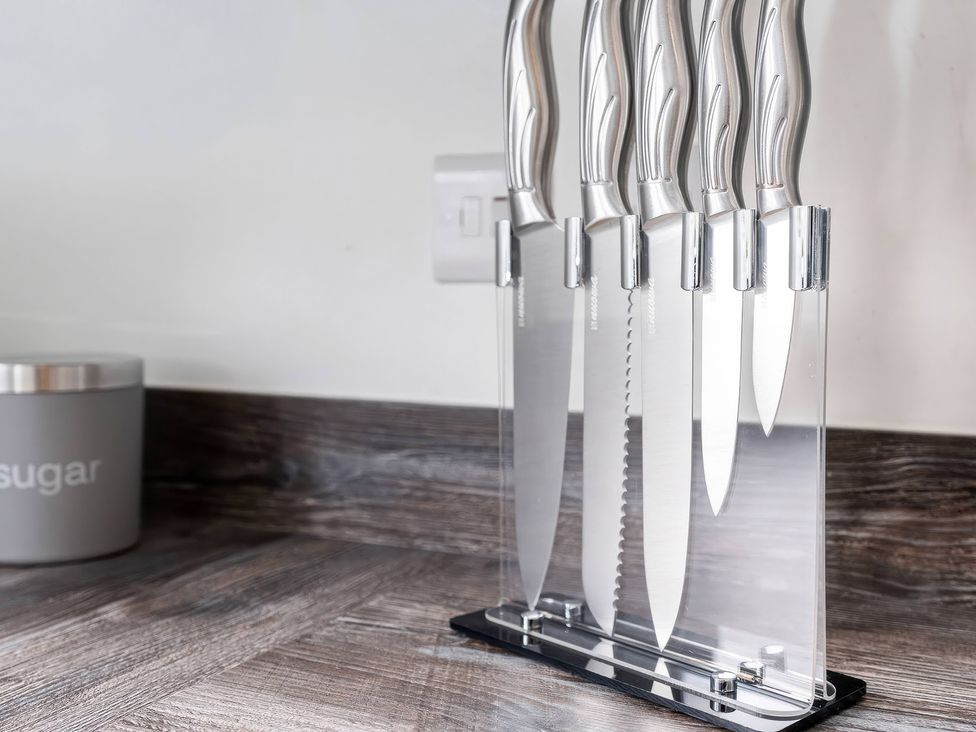 A knife block with knives and a sugar canister on a countertop at 59 Eagle Drive in Grimsby