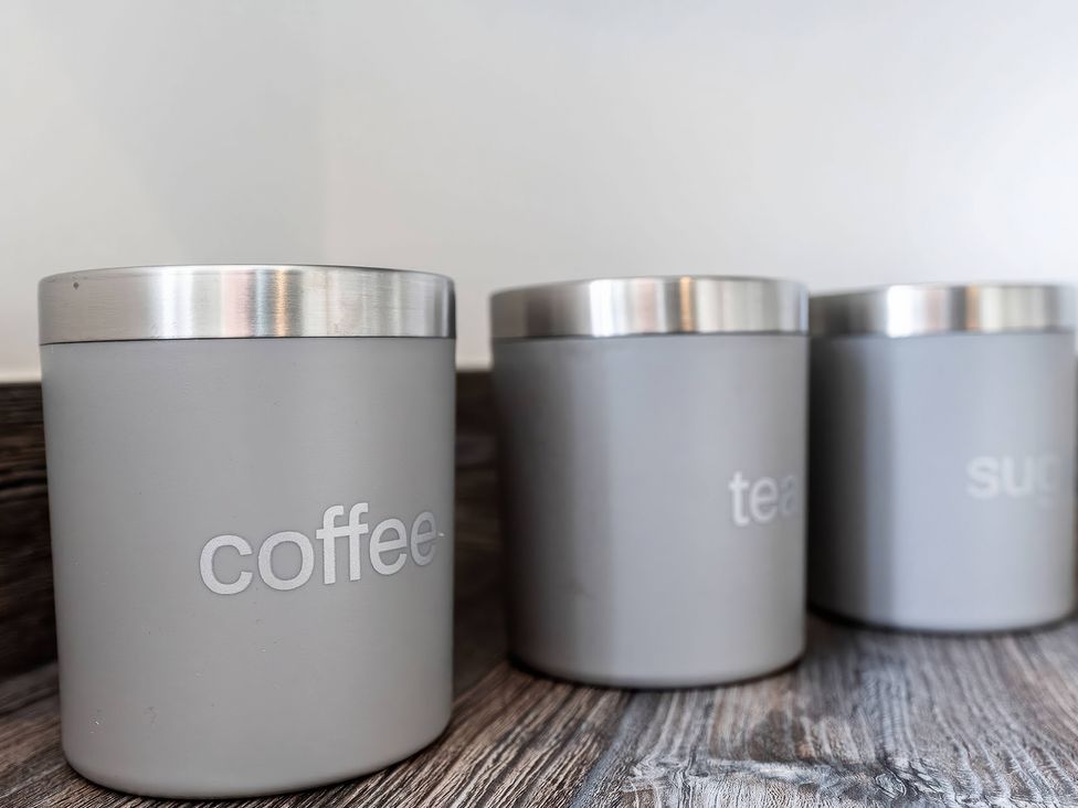 Three containers labeled for coffee, tea, and sugar in the kitchen at 59 Eagle Drive in Grimsby