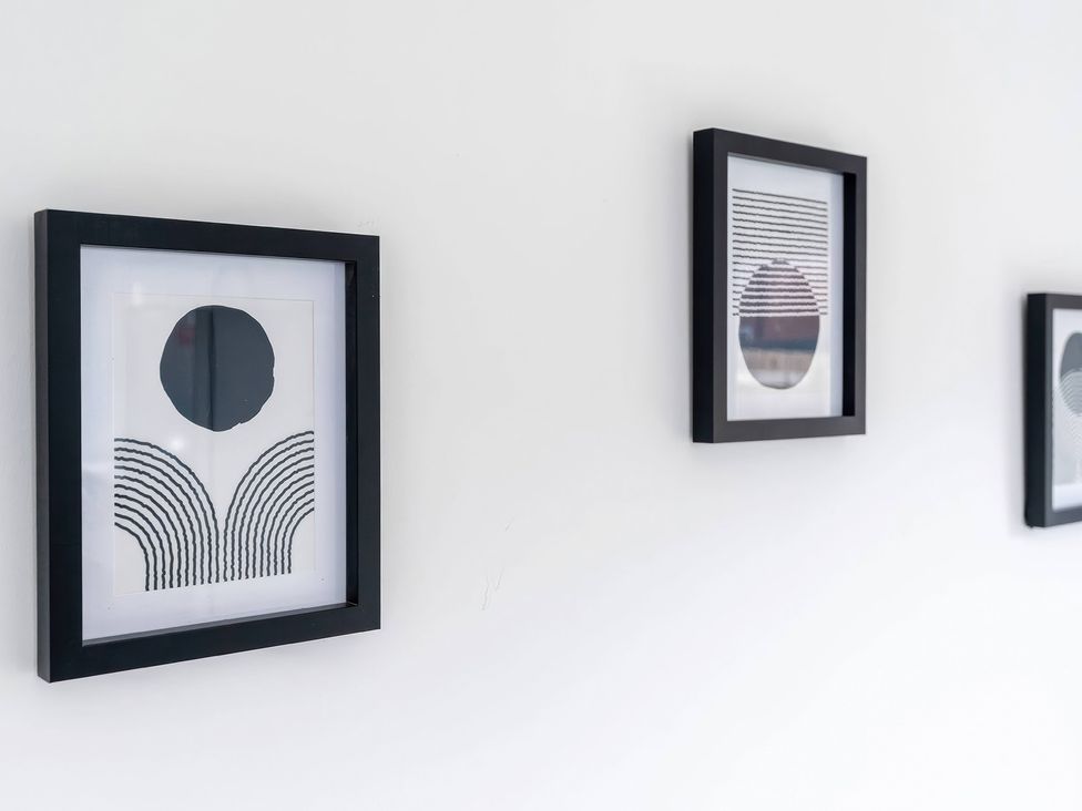 Three framed artworks on a white wall at 59 Eagle Drive in Grimsby