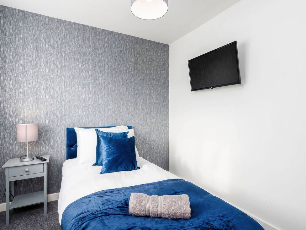 A bedroom with a bed and a TV at 59 Eagle Drive in Grimsby