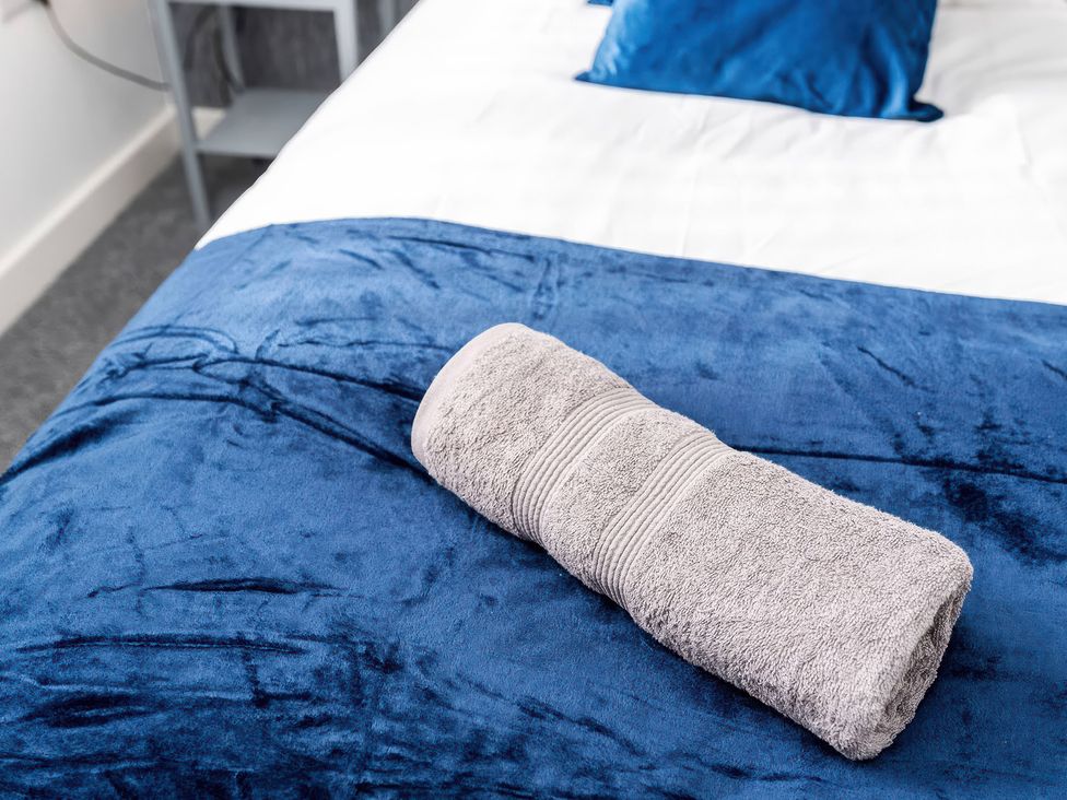 A towel on a bed with a blue blanket at 59 Eagle Drive in Grimsby