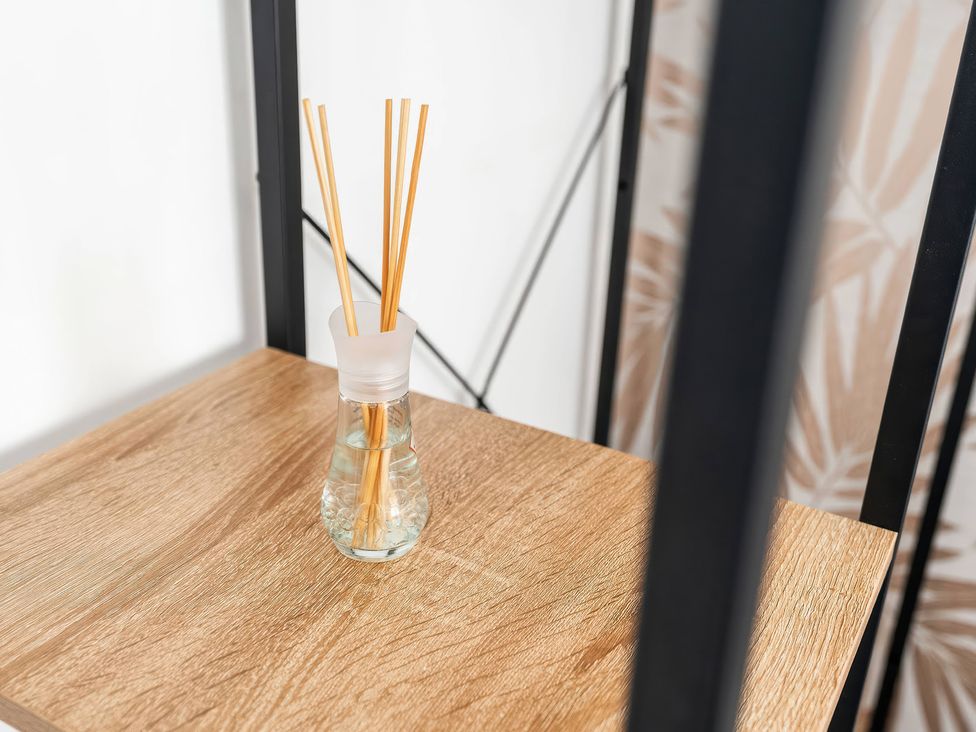 A reed diffuser on a wooden table at 59 Eagle Drive Grimsby