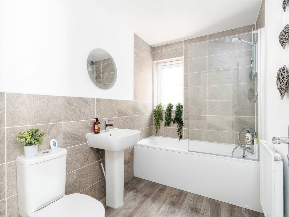 A bathroom with a toilet, wash basin and bathtub at 59 Eagle Drive in Grimsby