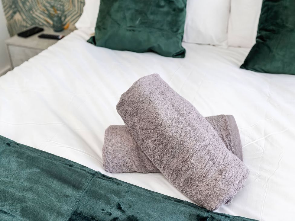 A bedroom with towels on the bed at 59 Eagle Drive, Grimsby