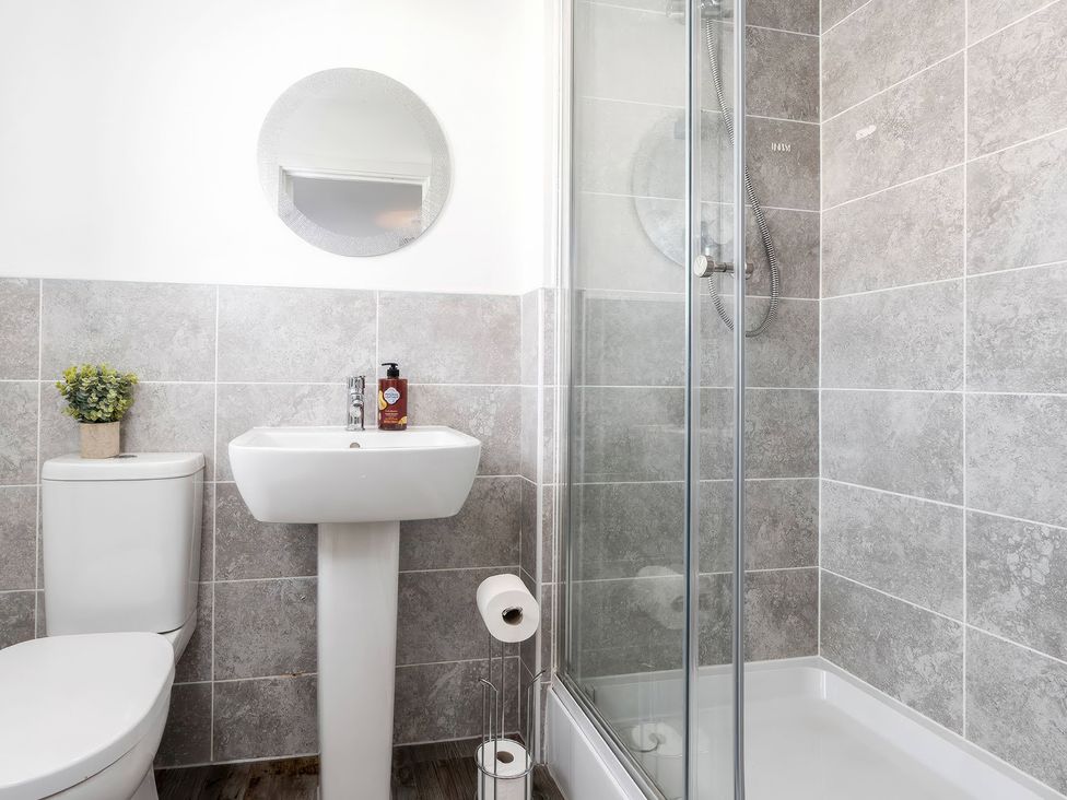 A bathroom with a sink and shower at 59 Eagle Drive in Grimsby
