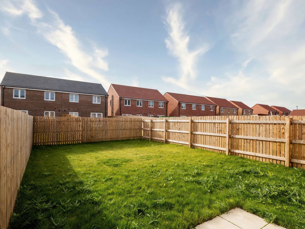 A garden with grass and a fence around it at 59 Eagle Drive in Grimsby