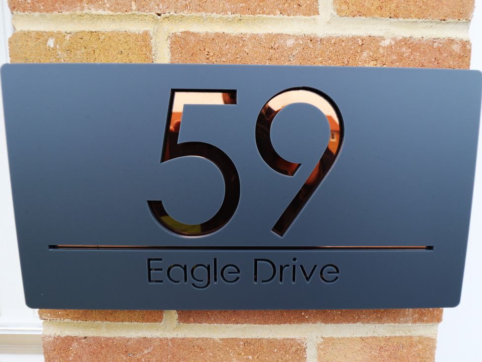 A house sign displaying number 59 and Eagle Drive at 59 Eagle Drive in New Waltham near Humberston, Lincolnshire