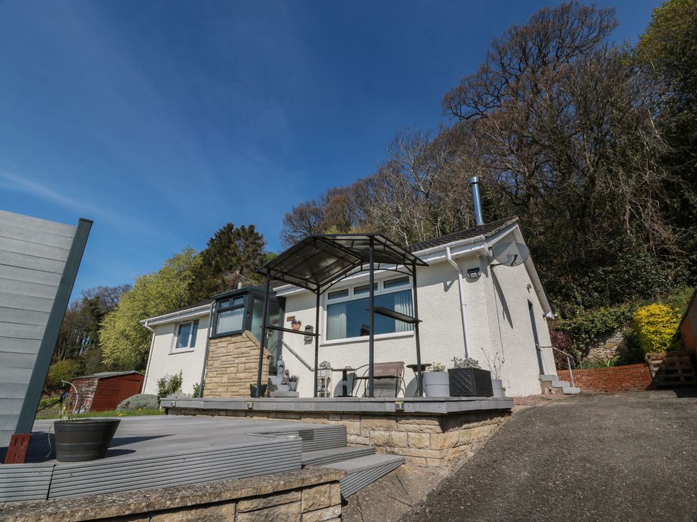 A house with a deck and planters at Crown Cottage in Newmills near Cairneyhill