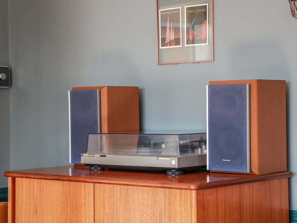A stereo unit with speakers and framed pictures at Crown Cottage in Newmills near Cairneyhill