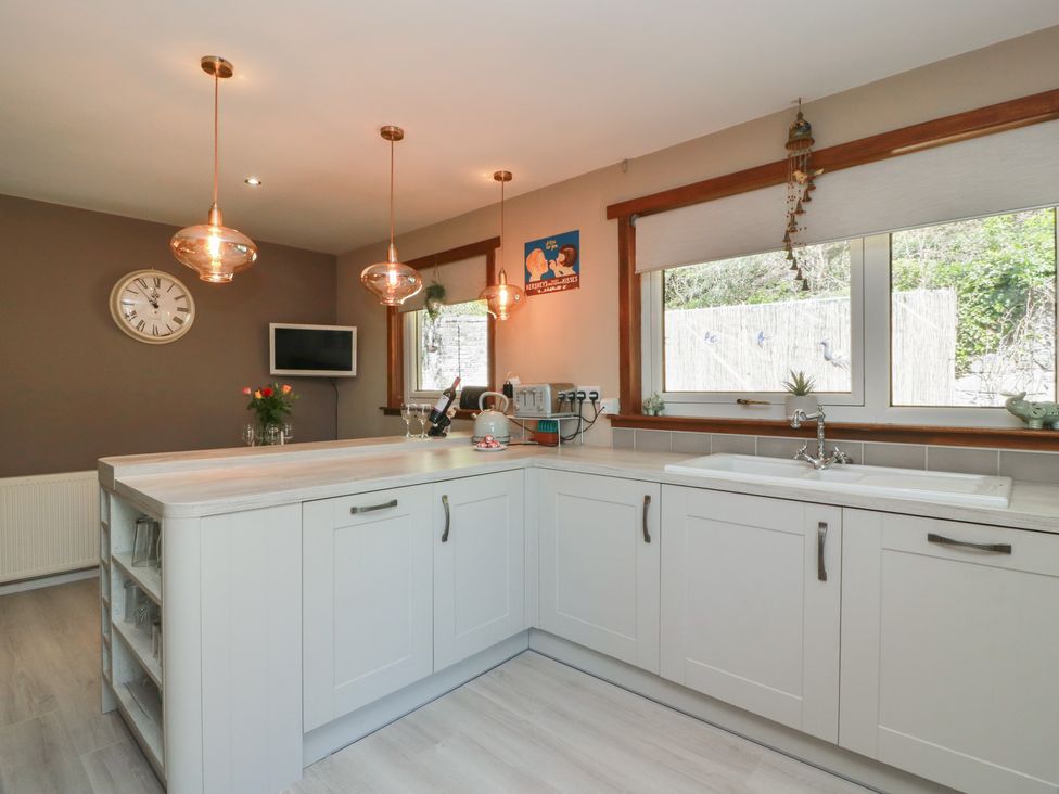 A kitchen with a sink and kitchen island at Crown Cottage near Newmills near Cairneyhill