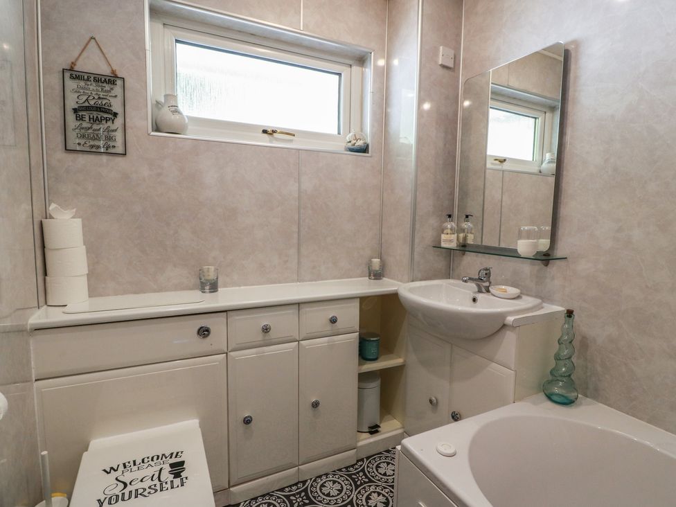 A bathroom with a sink and bathtub at Crown Cottage in Newmills near Cairneyhill