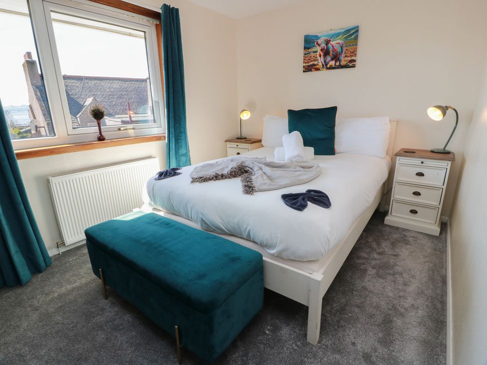 A bedroom with a bed and nightstand at Crown Cottage near Newmills near Cairneyhill