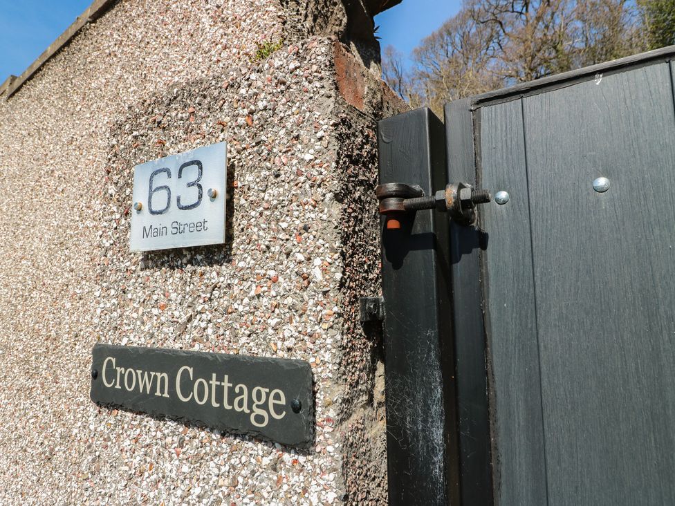 A house number sign and name plaque at Crown Cottage in Newmills near Cairneyhill