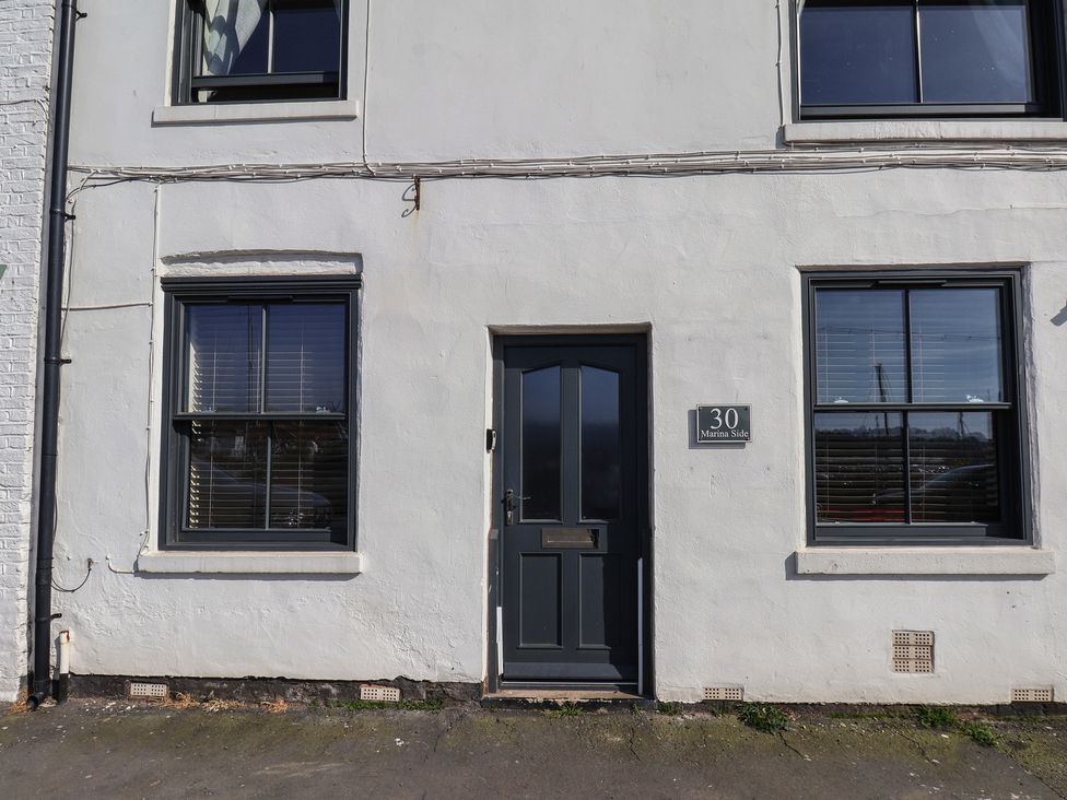 An exterior view of a building with a door and windows at Marina Side in Whitby