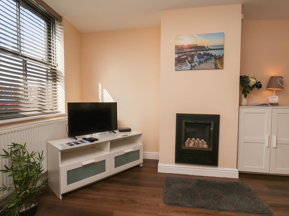 A living room with a television and fireplace at Marina Side in Whitby