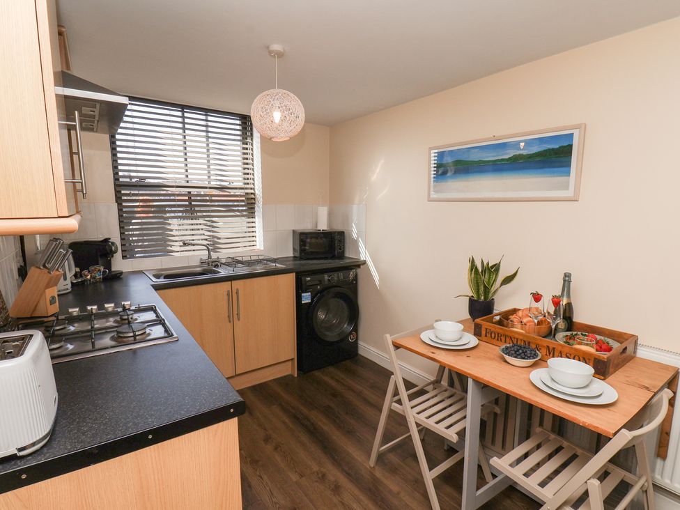 A kitchen with a table and chairs at Marina Side in Whitby