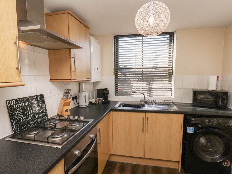 A kitchen with cabinets and appliances at Marina Side in Whitby